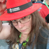 Photo of Victoria Kariolic wearing a Carmen Sandiego hat at New York Comic Con 2018